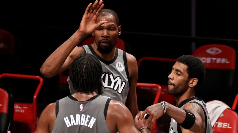 Kevin Durant (centre), Kyrie Irving (right) and James Harden are looking to bring a championship to Brooklyn (AP)