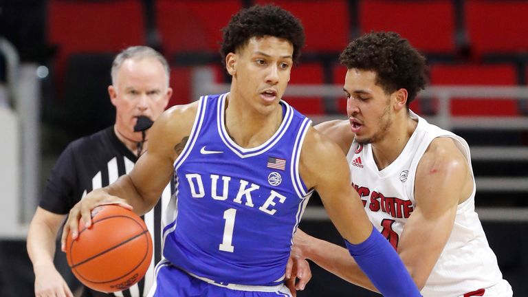 Duke's Jalen Johnson (1) looks for space as N.C. State's Jericole Hellems (4) defends during the first half of N.C. State's game against Duke at PNC Arena in Raleigh, N.C., Saturday, February 13, 2021.