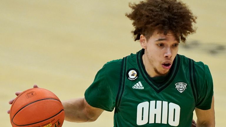 Ohio's Jason Preston (0) drives to the basket against Buffalo's Ronaldo Segu (10) during the first half of an NCAA college basketball game in the championship of the Mid-American Conference tournament, Saturday, March 13, 2021, in Cleveland. (AP Photo/Tony Dejak)