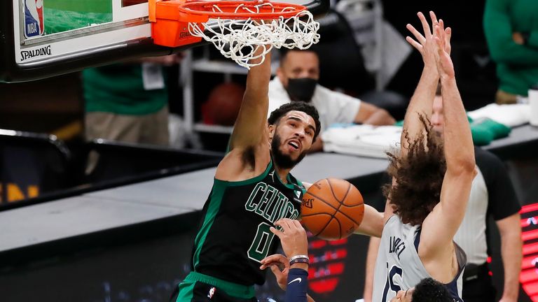 Boston Celtics&#39; Jayson Tatum (0) dunks against Washington Wizards&#39; Robin Lopez (15) during the first half of an NBA basketball game, Sunday, Feb. 28, 2021, in Boston.