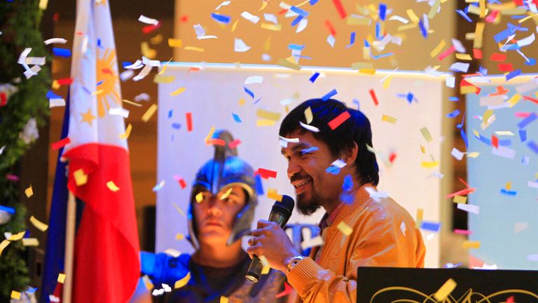 Confetti rain on Filipino boxer and Congressman Manny Pacquiao during a news conference upon arrival in Manila, Philippines early Saturday June 16, 2012 from Los Angeles.  Pacquiao, who lost his WBO Welterweight title to American Timothy Bradley via a controversial split decision June 9, 2012, arrived Saturday to check the situation in his home province of Sarangani in southern Philippines following floodings that affected thousands of residents.  (AP Photo/Bullit Marquez)