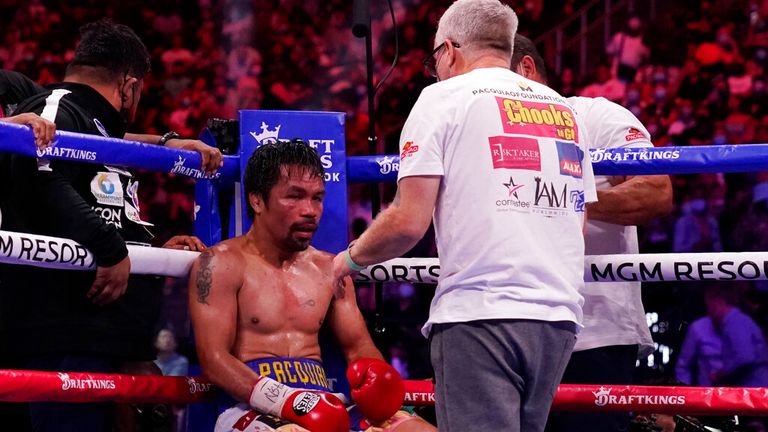 Trainer Freddie Roach speaks to Manny Pacquiao, of the Philippines, between rounds against Yordenis Ugas, of Cuba, in a welterweight championship boxing match Saturday, Aug. 21, 2021, in Las Vegas. (AP Photo/John Locher)