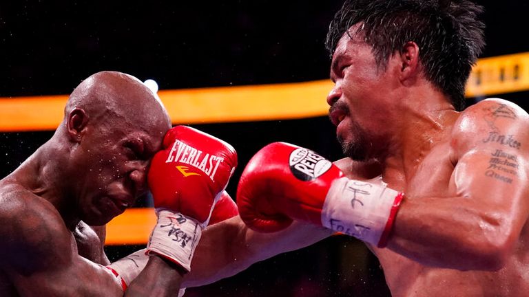 Manny Pacquiao, right, of the Philippines, hits Yordenis Ugas, of Cuba, in a welterweight championship boxing match Saturday, Aug. 21, 2021, in Las Vegas. (AP Photo/John Locher)