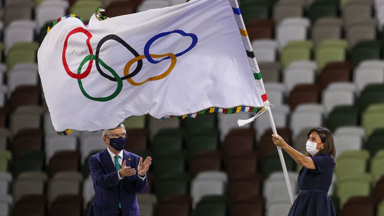 Paris Mayor Anne Hidalgo waves the Olympic flag after receiving it from International Olympic Committee's President Thomas Bach during the closing ceremony in the Olympic Stadium at the 2020 Summer Olympics, Sunday, Aug. 8, 2021, in Tokyo, Japan. (Dan Mullen/Pool Photo via AP))