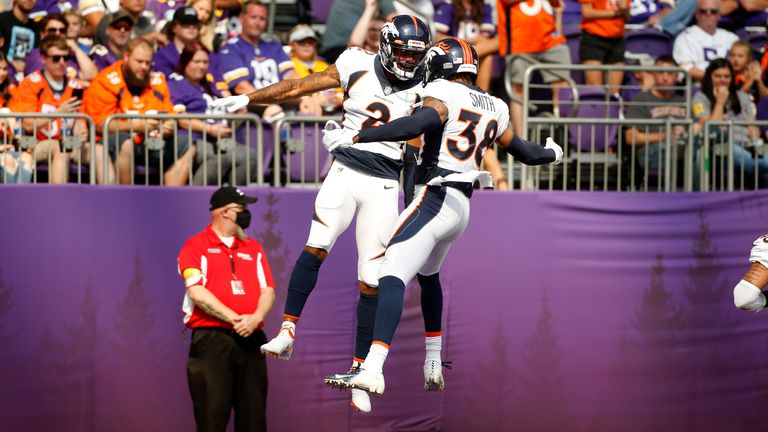 Surtain II (2) celebrates his interception against the Vikings with teammate Saivion Smith (38) (AP Photo/Bruce Kluckhohn)