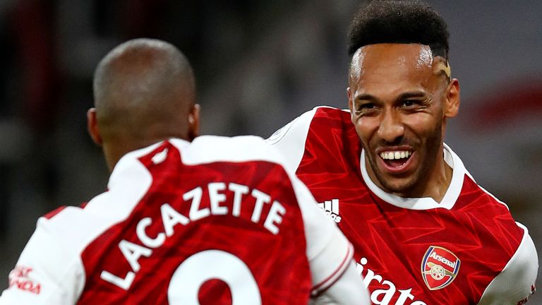 Arsenal...s Alexandre Lacazette celebrates with Arsenal...s Pierre-Emerick Aubameyang after scoring the opening goal during the English Premier League soccer match between Arsenal and West Ham at the Emirates Stadium in London, England, Saturday, Sept. 19, 2020. (Julian Finney/Pool via AP)