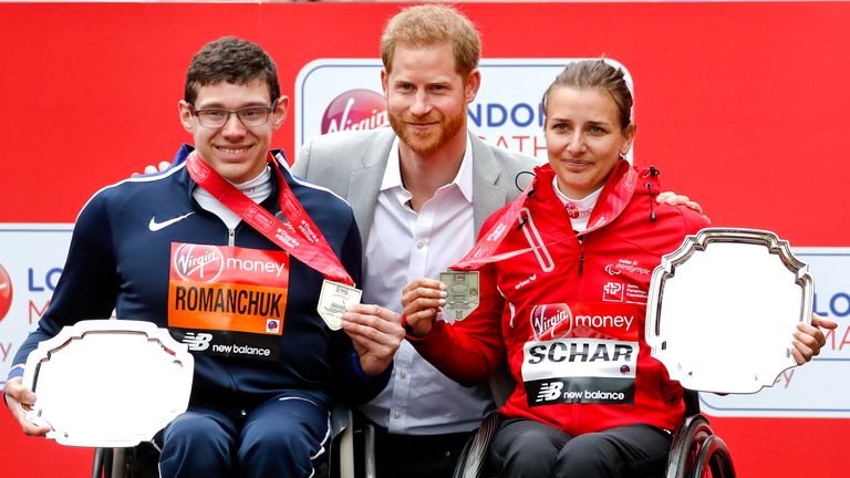 Prince Harry with the wheelchair race winner Romanchuk and women's winner Manuela Scharat of Stitzerland at the London Marathon in 2019