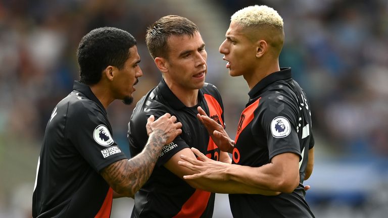 Richarlison is held back by teammates Allan and Seamus Coleman after a dispute over who should take a penalty