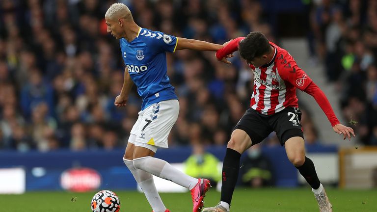 Richarlison (L) and Southampton's Tino Livramento battle for the ball