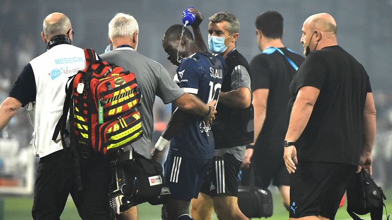 Bordeaux's Nigerian forward Samuel Kalu leaves the pitch surrounded by medics