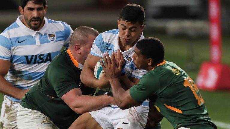 Santiago Chocobares of Argentina is tackled by Wilco Louw of South Africa and Damian Willemse of South Africa during the first Rugby Championship match between South Africa's Springboks and Argentina at the Nelson Mandela Stadium, in Gqeberha, South Africa, Saturday, Aug. 14, 2021. (AP Photo/Halden Krog)