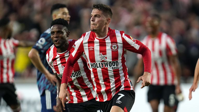 Brentford's Sergi Canos (centre) celebrates scoring their side's first goal of the game during the Premier League match at the Brentford Community Stadium, London. Picture date: Friday August 13, 2021.