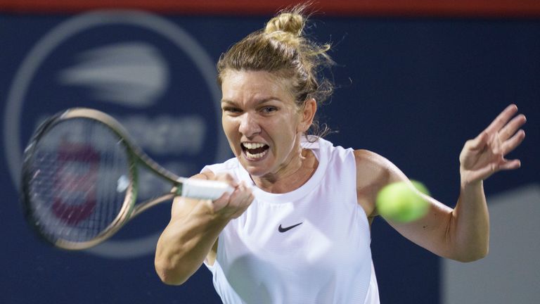 Simona Halep, of Romania, returns to Danielle Collins, of the United States, during their match at the National Bank Open women's tennis tournament Wednesday, Aug. 11, 2021, in Montreal. (Paul Chiasson/The Canadian Press via AP)