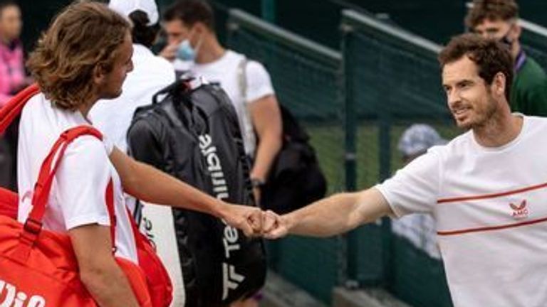 Stefanos Tsitsipas (GRE) and Andy Murray (GBR) bump fists as they meet outside of the Aorangi Practice Courts at The All England Lawn Tennis and Croquet Club. Picture date: Saturday June 26, 2021.