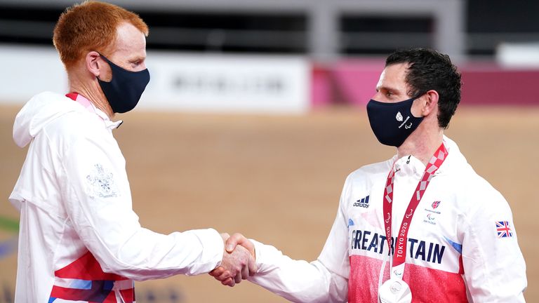 Great Britain's Stephen Bate (L) and pilot Adam Duggleby with the silver medal after the men's B 4000m Individual Pursuit Final at the Izu Velodrome