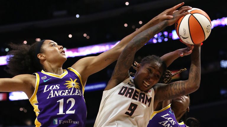 Crystal Bradford #9 of the Atlanta Dream competes for a rebound against Nia Coffey #12 and Te&#39;a Cooper #2 of the Los Angeles Sparks during the first half of a game at Staples Center on August 17, 2021 in Los Angeles, California. 