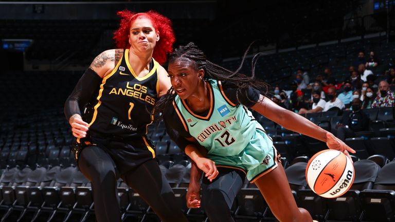 Michaela Onyenwere #12 of the New York Liberty handles the ball as Amanda Zahui B #1 of the Los Angeles Sparks plays defense during the game on August 22, 2021 at Barclays Center in Brooklyn, New York. 