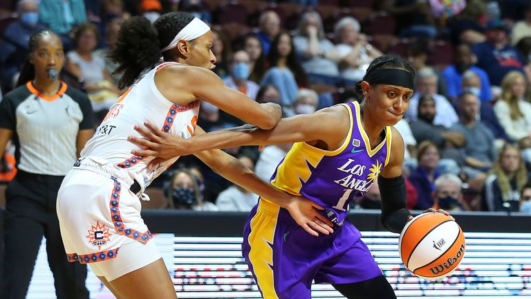 Los Angeles Sparks guard Brittney Sykes (15) drives past Connecticut Sun guard Jasmine Thomas (5) during a WNBA game between Los Angeles Sparks and Connecticut Sun on August 28, 2021, at Mohegan Sun Arena in Uncasville, CT. 