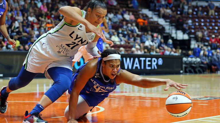 UNCASVILLE, CT - August 17: Connecticut Sun forward Brionna Jones (42) and Minnesota Lynx guard Kayla McBride (21) battle for the loose ball during a WNBA game between Minnesota Lynx and Connecticut Sun on August 17, 2021, at Mohegan Sun Arena in Uncasville, CT.