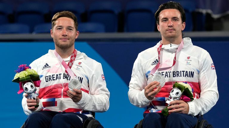 Britain's Alfie Hewett, left, and Gordon Reid pose with the silver medal during the victory ceremony of Wheelchair tennis men's doubles event at the Tokyo 2020 Paralympic Games, Friday, Sept. 3, 2021, in Tokyo, Japan. (AP Photo/Shuji Kajiyama)