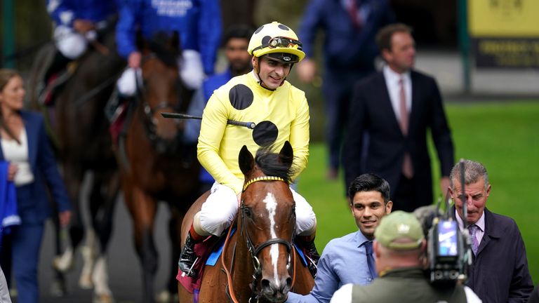 Andrea Atzeni and Triple Time are led back into the winner's enclosure at Haydock