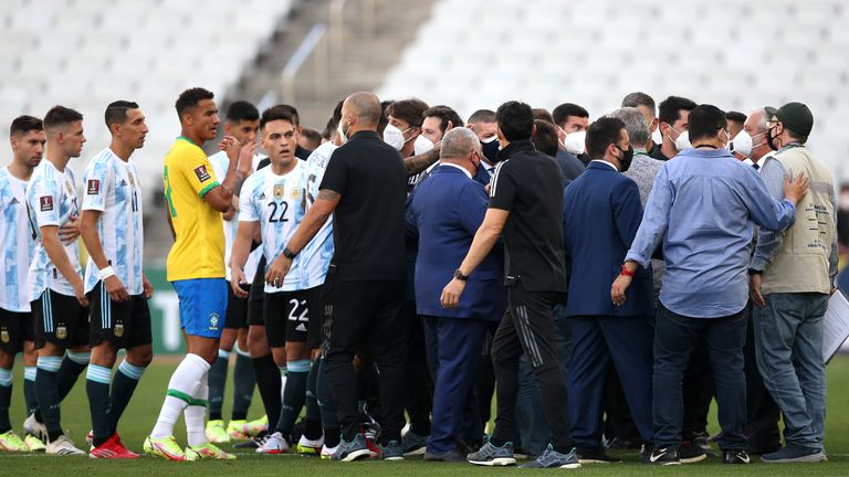 Argentina and Brazil players are surrounded by officials during their World Cup qualifier