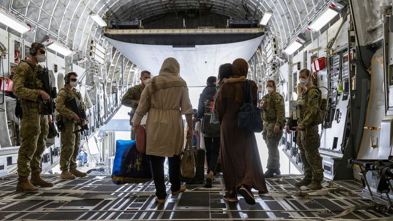 In this image provided by the Australian Defence Force on Aug. 22, 2021, Afghanistan evacuees arrive at Australia...s main operating base in the Middle East, on board a Royal Australian Air Force C-17A Globemaster. The government has not commented on media reports that Australia plans to evacuate 600 Australians and Afghans. (Leading Aircraftwoman Jacqueline Forrester/Australian Defence Force via AP)
