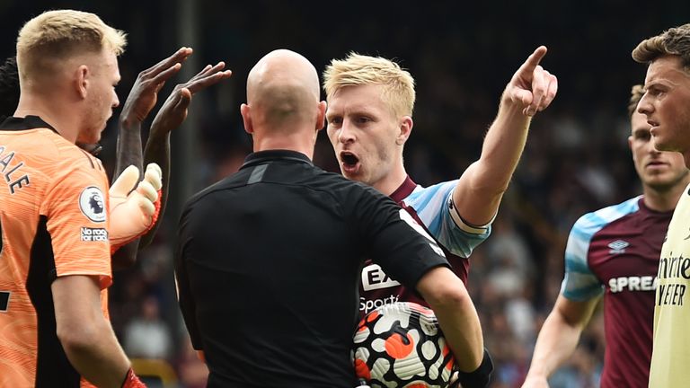 Ben Mee confronts referee Anthony Taylor after a penalty for Burnley is overturned