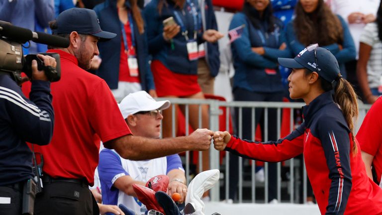 Danielle Kang gets a high five from Bubba Watson at the first tee during the morning foursome matches at Inverness Club 