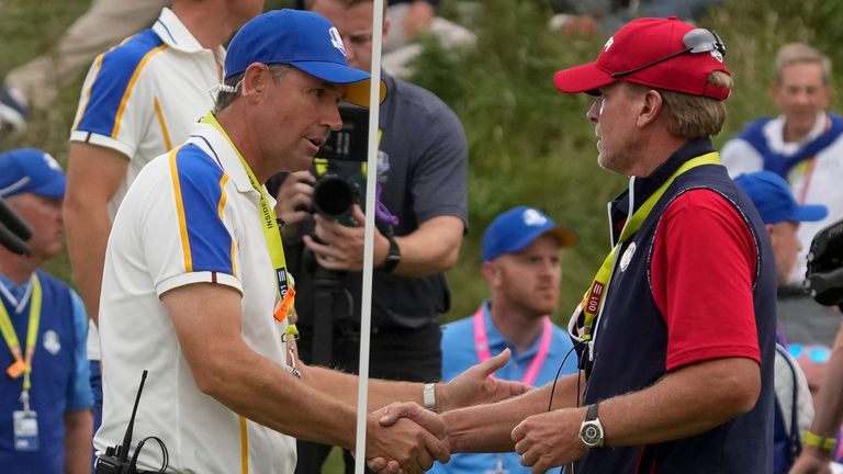 Team USA captain Steve Stricker shakes hands with Team Europe captain Padraig Harrington after the Ryder Cup matches at the Whistling Straits Golf Course Sunday, Sept. 26, 2021, in Sheboygan, Wis. (AP Photo/Charlie Neibergall) 