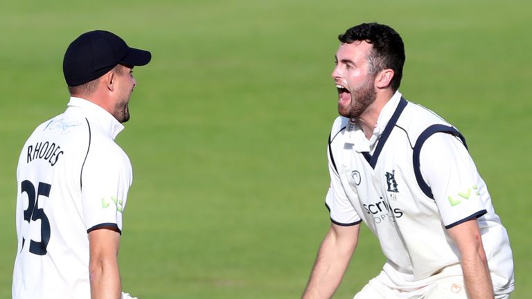 Warwickshire's Liam Norwell (R) celebrates with captain Will Rhodes after taking the wicket that sealed the 2021 County Championship title (PA Images)