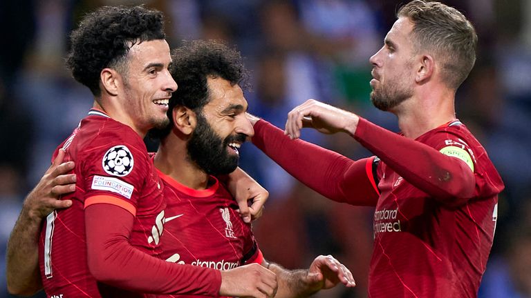 Curtis Jones celebrates with Mo Salah and Jordan Henderson