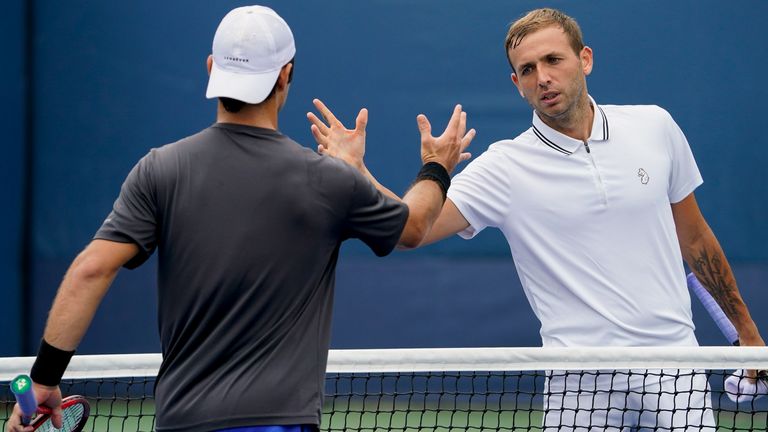 Dan Evans, of Great Britain, right, shakes hands with Marcos Giron, of the United States, after winning their second round match of the US Open tennis championships, Wednesday, Sept. 1, 2021, in New York. (AP Photo/John Minchillo)