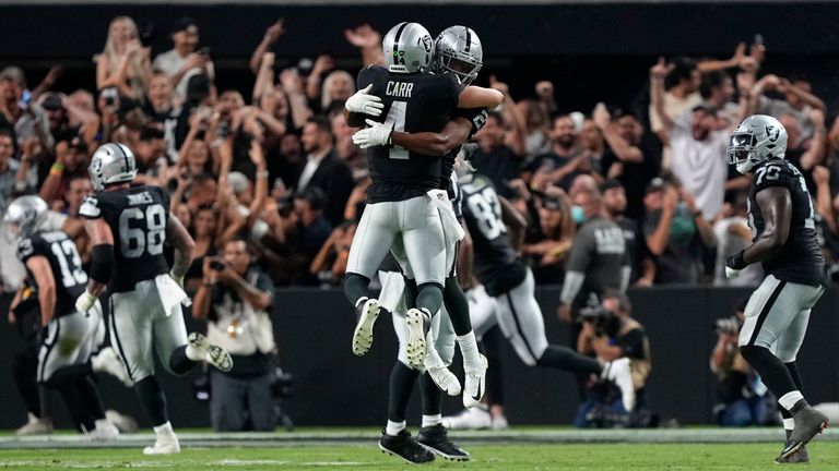 Las Vegas Raiders quarterback Derek Carr celebrates with teammates after defeating the Baltimore Ravens in overtime