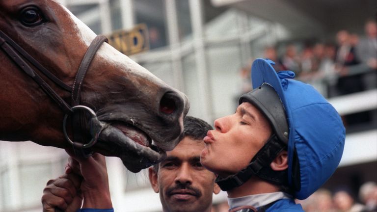 Frankie Dettori kisses his mount, Mark of Esteem, after their triumph in the Queen Elizabeth II Stakes