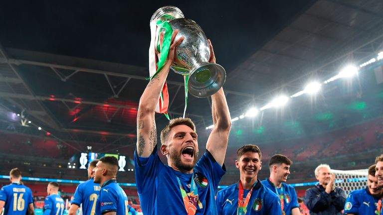 Italy&#39;s Domenico Berardi celebrates with the trophy after the final of the Euro 2020 soccer final match between England and Italy at Wembley stadium in London, Sunday, July 11, 2021. (Andy Rain/Pool Photo via AP)