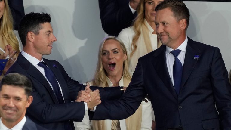 Team Europe's Rory McIlroy shakes hands with Team Europe's Ian Poulter after it was announced they would play together in Friday...s foursomes during the opening ceremony for the Ryder Cup at the Whistling Straits Golf Course Thursday, Sept. 23, 2021, in Sheboygan, Wis. (AP Photo/Charlie Neibergall)