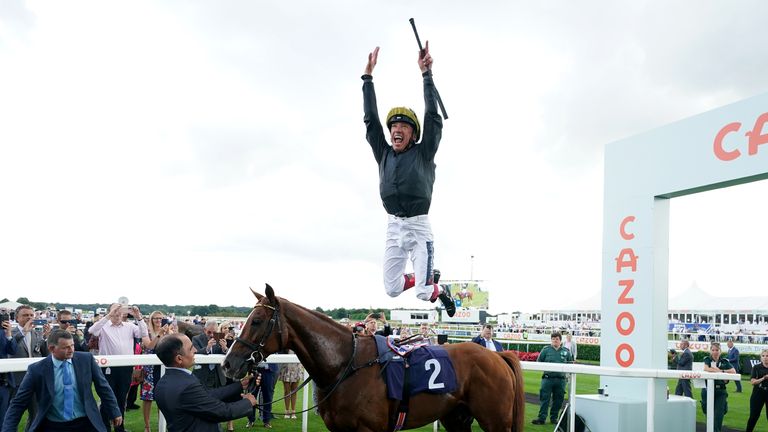 Frankie Dettori performs his famous flying dismount from Stradivarius after winning the Doncaster Cup