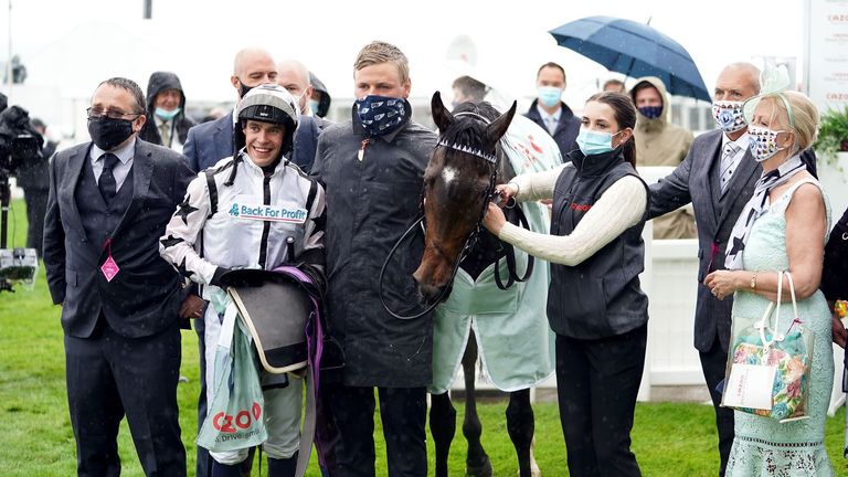 George Boughey (centre) with jockey Mark Crehan and Oscula after winning at Epsom