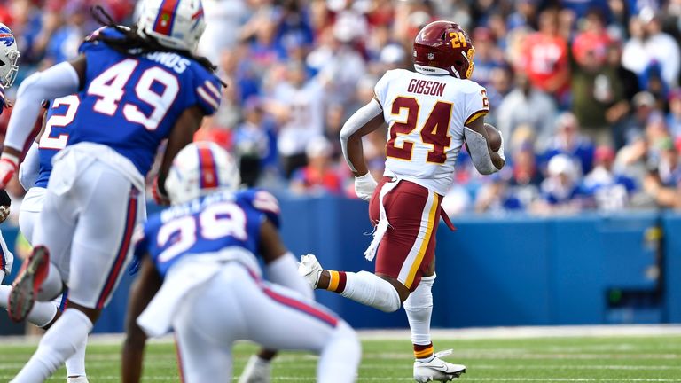 Washington Football Team&#39;s Antonio Gibson (24) runs away from Buffalo Bills defenders for a touchdown during the first half of an NFL football game Sunday, Sept. 26, 2021, in Orchard Park, N.Y. (AP Photo/Adrian Kraus)