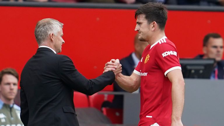 Harry Maguire shakes hands with Ole Gunnar Solskjaer as he leaves the pitch (AP)