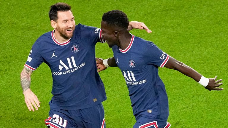 PSG's Idrissa Gueye, right, celebrates with teammate Lionel Messi after scoring his team's first goal during the Champions League Group A soccer match between Paris Saint-Germain and Manchester City at the Parc des Princes in Paris, Tuesday, Sept. 28, 2021. (AP Photo/Michel Euler)