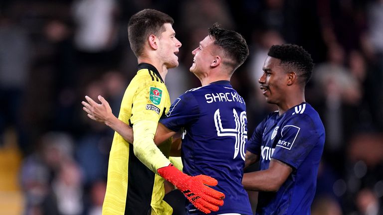 Leeds United goalkeeper Illan Meslier (left) is congratulated by team-mates after saving the decisive penalty