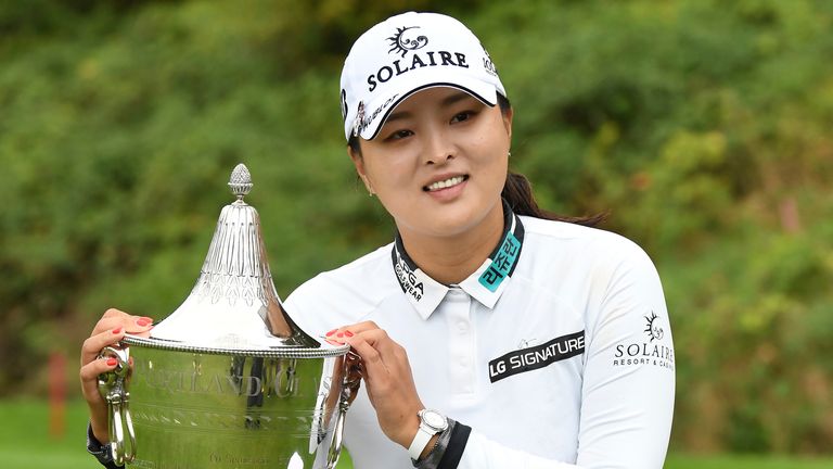Jin Young Ko poses with the trophy 