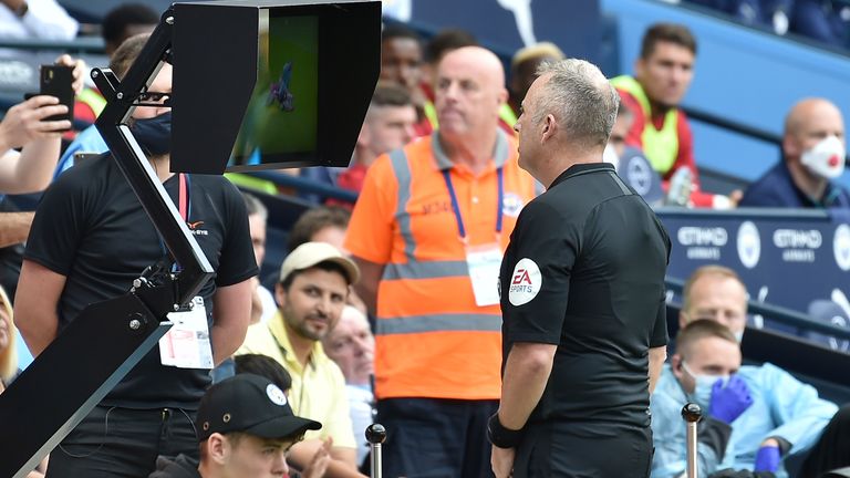 Referee Jon Moss goes to the pitchside monitor to review a Kyle Walker challenge, before overturning his decision to send off the Man City defender and award Southampton a penalty