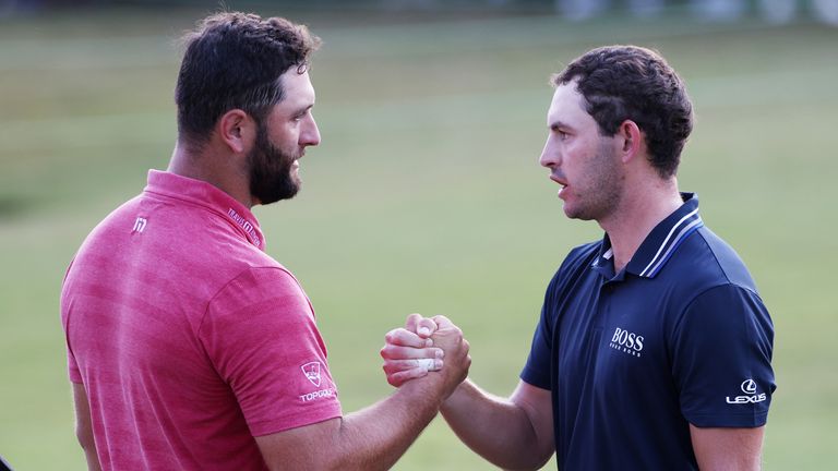 Jon Rahm of Spain congratulates Patrick Cantlay of the United States on the 18th green after Cantlay won during the final round of the TOUR Championship at East Lake Golf Club