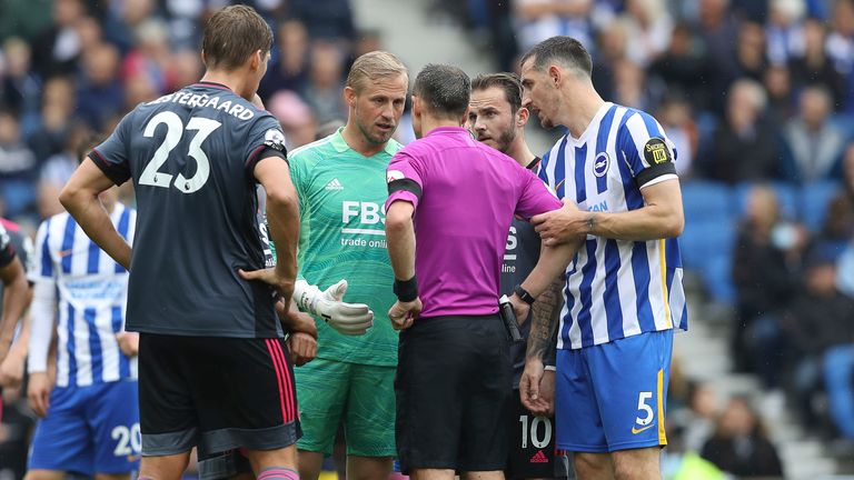 Kasper Schmeichel talks to referee Stuart Attwell after he awards Brighton a penalty 