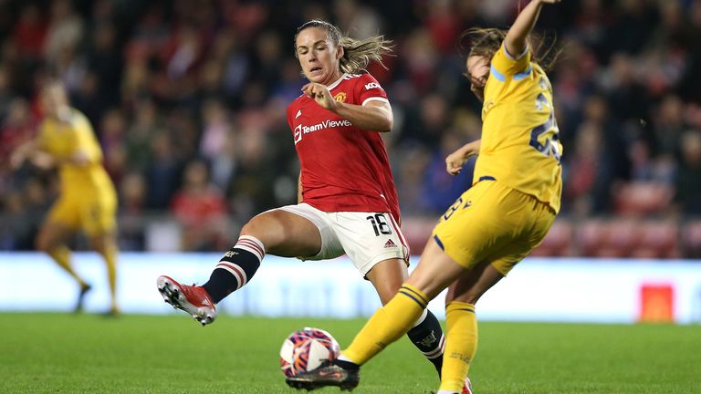 Kirsty Hanson of Manchester United challenges Lily Woodham of Reading during the WSL opener