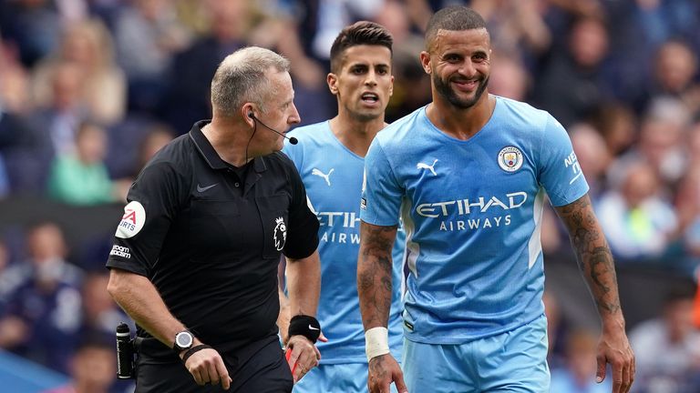 Kyle Walker smiles after his reprieve from referee Jonathan Moss