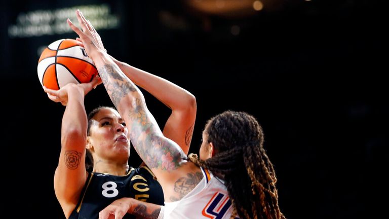 Las Vegas Aces center Liz Cambage (8) takes a shot over Phoenix Mercury center Brittney Griner (42) during the second half of Game 1 in the semifinals of the WNBA playoffs Tuesday, Sept. 28, 2021, in Las Vegas. The Aces beat the Mercury 96-90. (AP Photo/Steve Marcus)